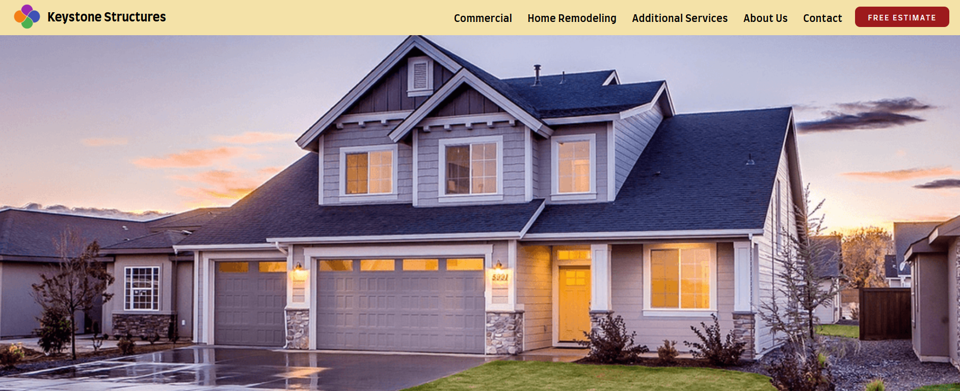 The hero image of a construction website showing a modern two-story house with lit windows, triple garage, and well-kept front yard at dusk.