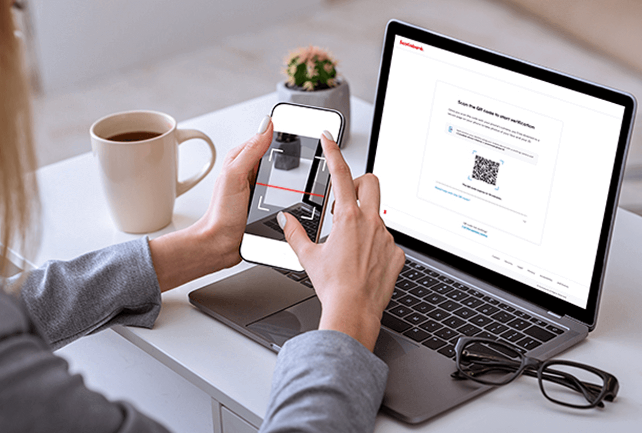 A person scanning QR code on their laptop