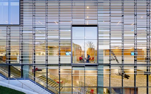 A detail view of an all-glass building facade. 