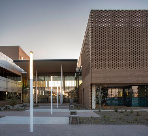 A government building with a brick screen. 