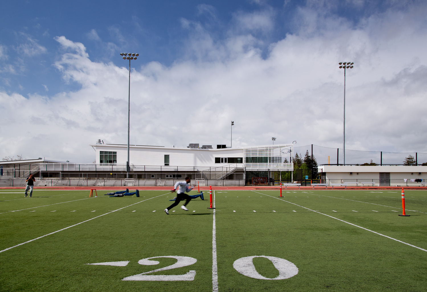 Athlete running on turf field.