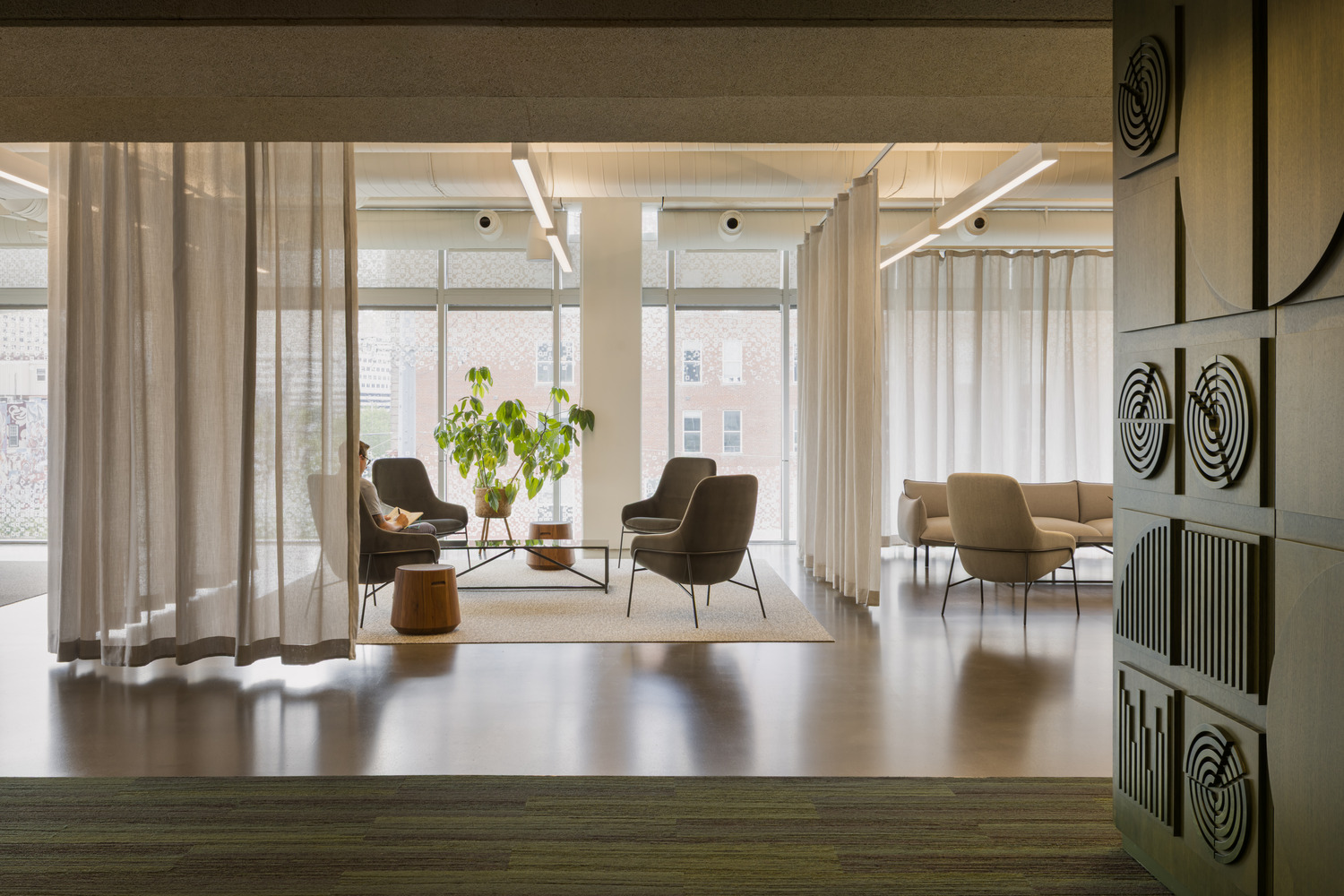 A one-point view of sitting area within a workplace environment.