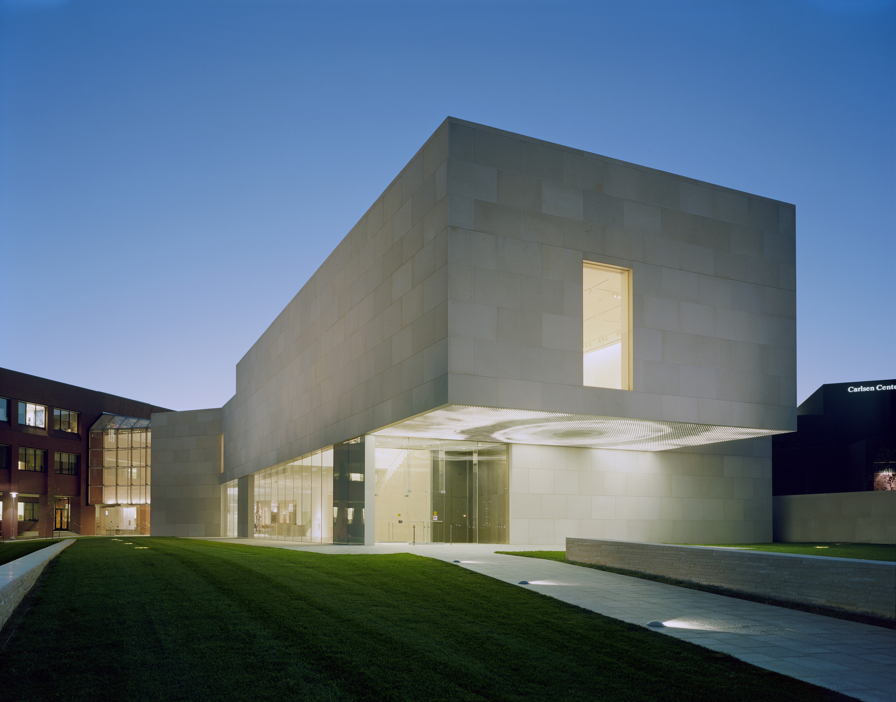 The underside of a limestone cantilever is illuminated with and LED art fixture.