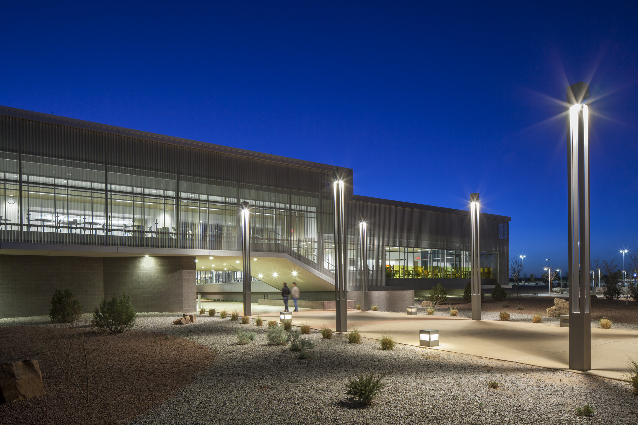 Bright lights in and around Central New Mexico Community College illuminate the campus as dusk turns to dark. 