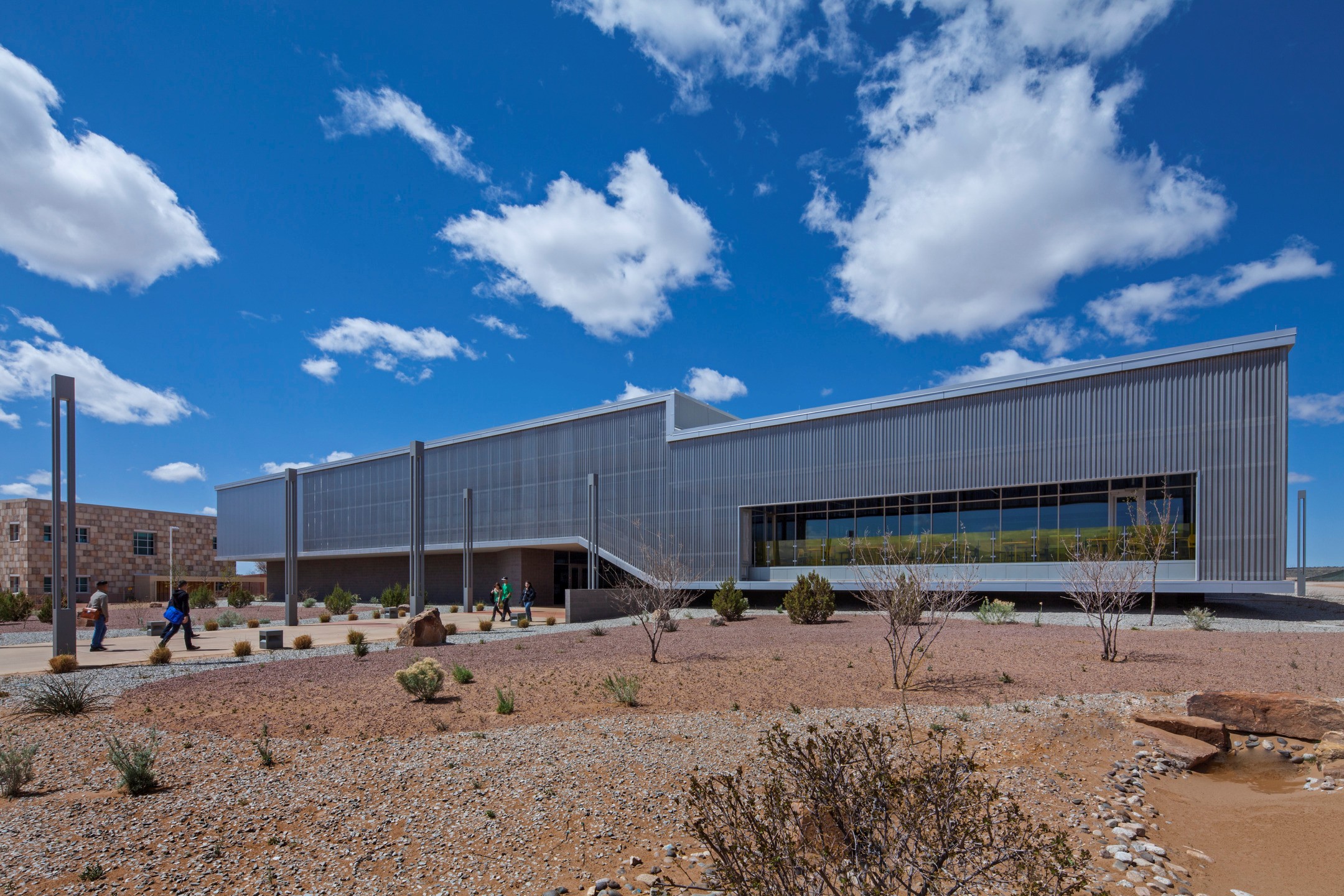The metal envelope around Central New Mexico Community College contrasts with the surrounding desert environment, distinguishing itself as a destination. 