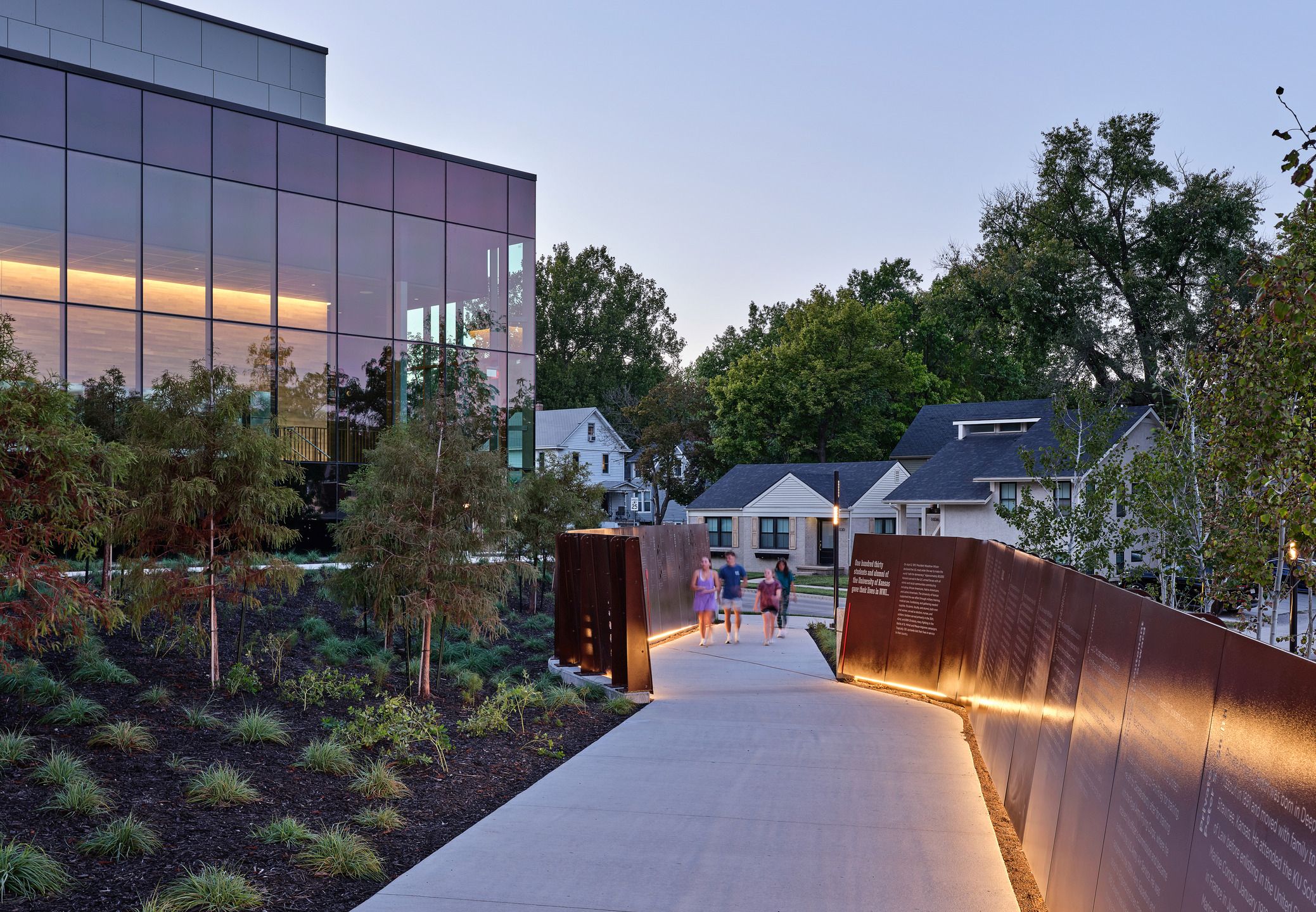 Visitors walk through the World War I memorial outside the University of Kansas David Booth Memorial Stadium.