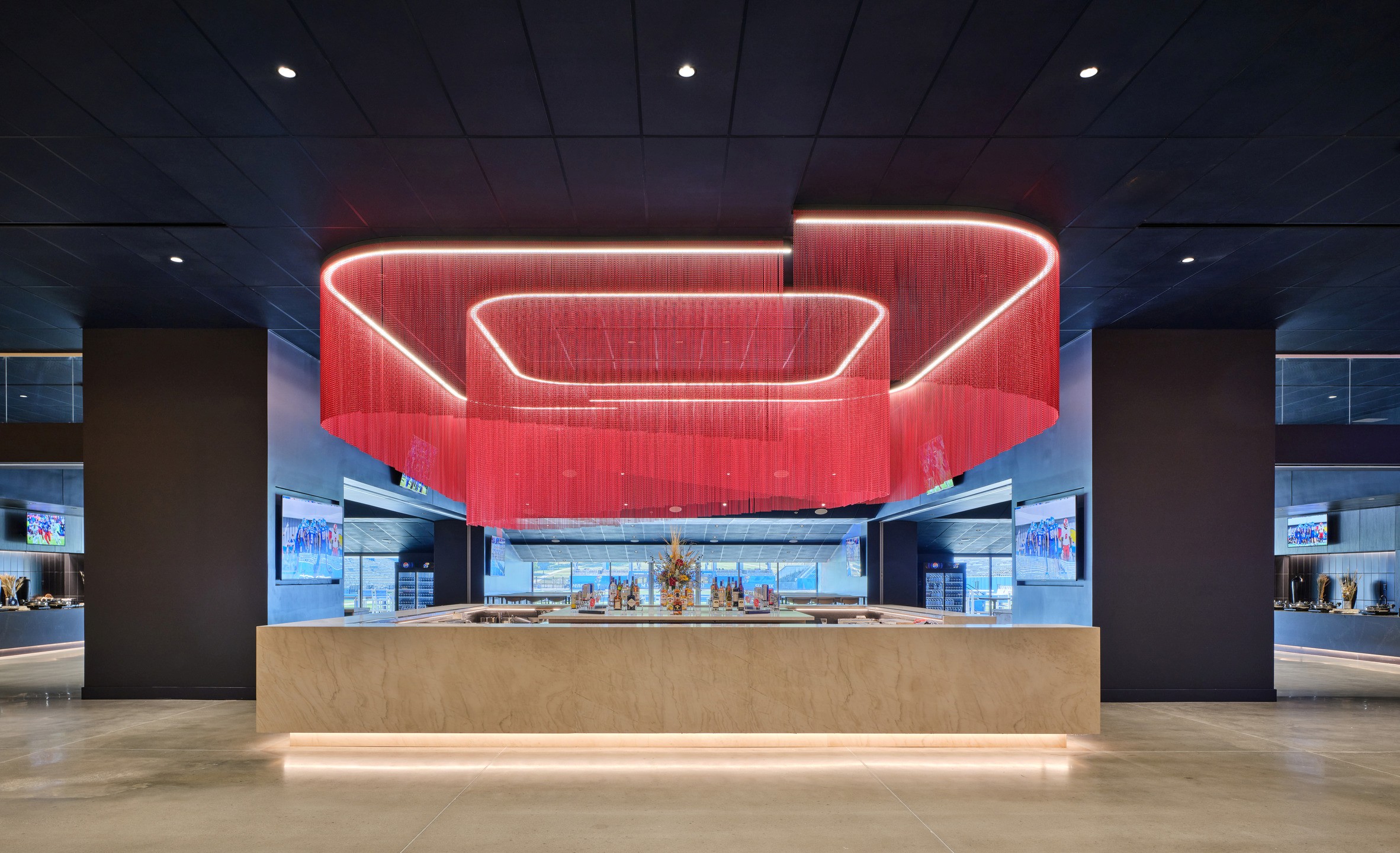 A 360-degree bar is positioned below an illuminated red sculpture. 