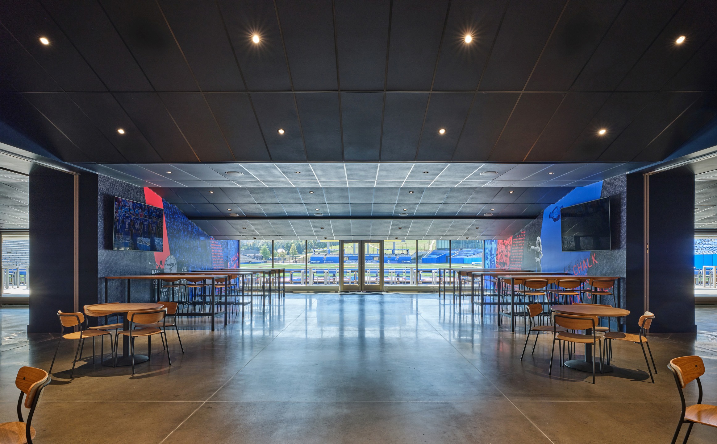 The Field Club opens onto the stadium's north end zone through floor-to-ceiling glass windows. 
