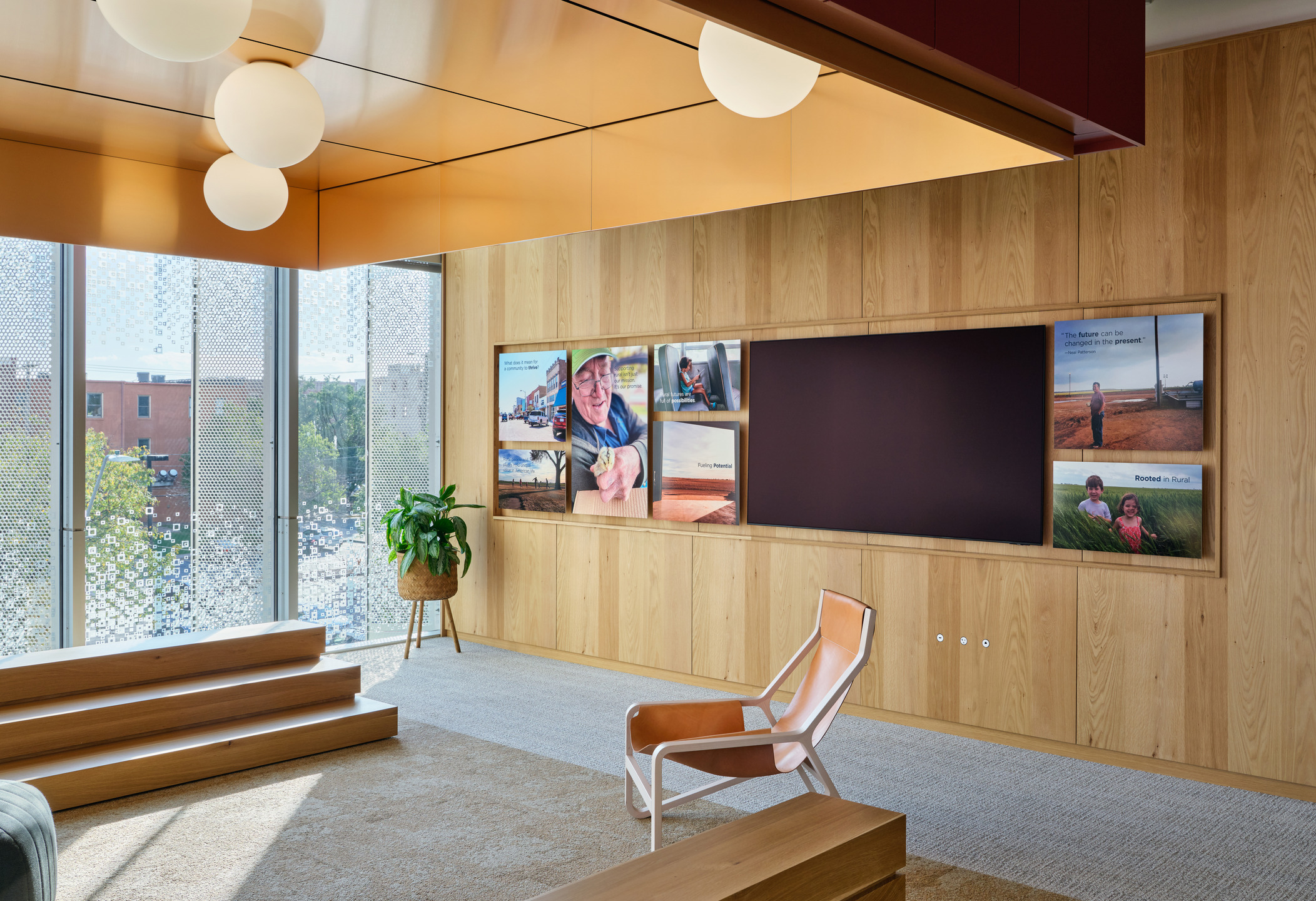 A woman sits outdoors, looking at a designed billboard. 