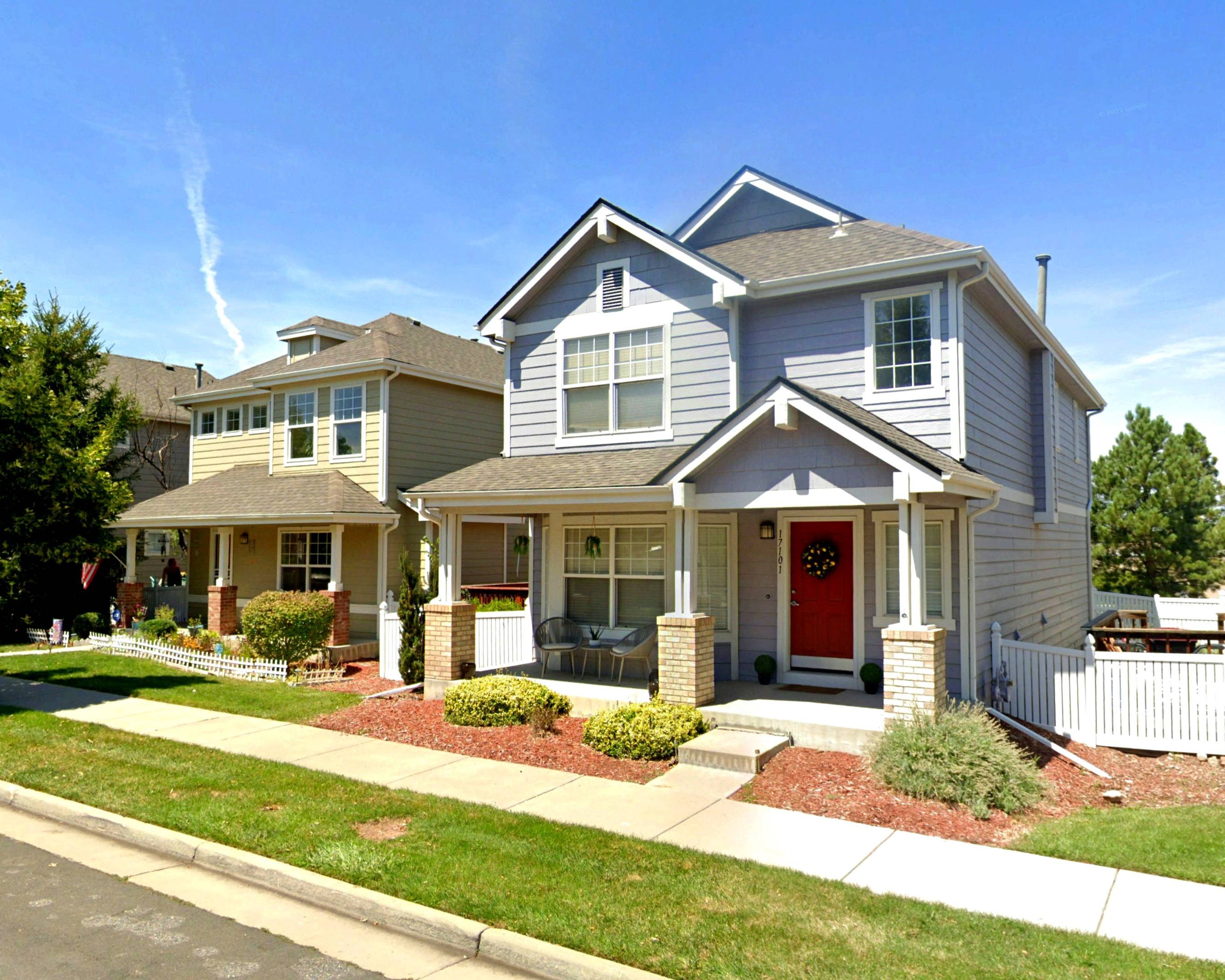 Single-family houses line a neighborhood street in Aurora. 