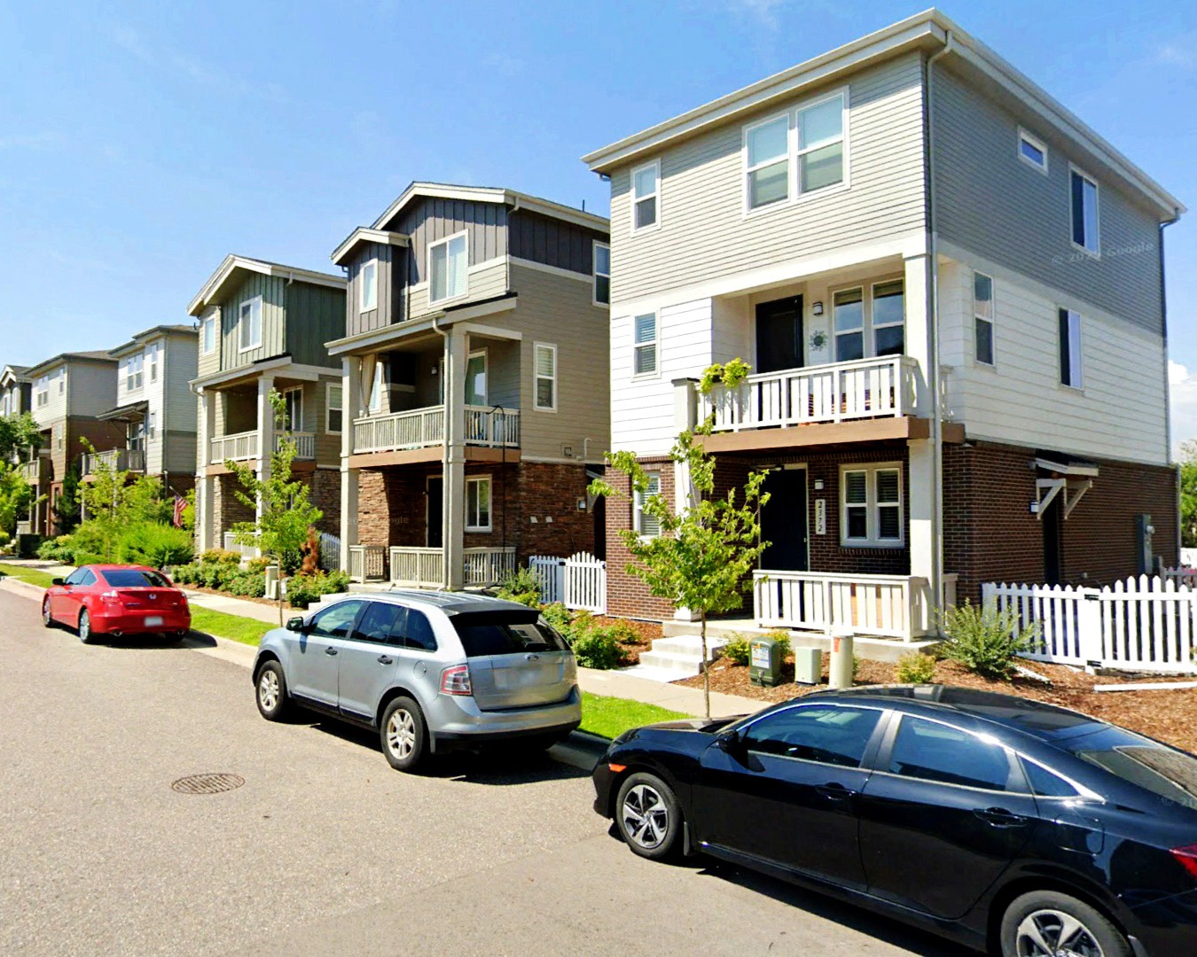 Multi-family houses line a neighborhood street in Aurora. 
