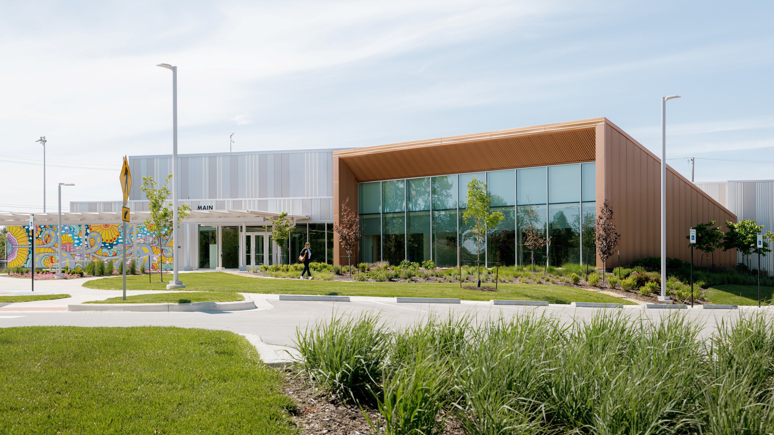 A person walks in front of the Lenexa Old Town Activity Center.