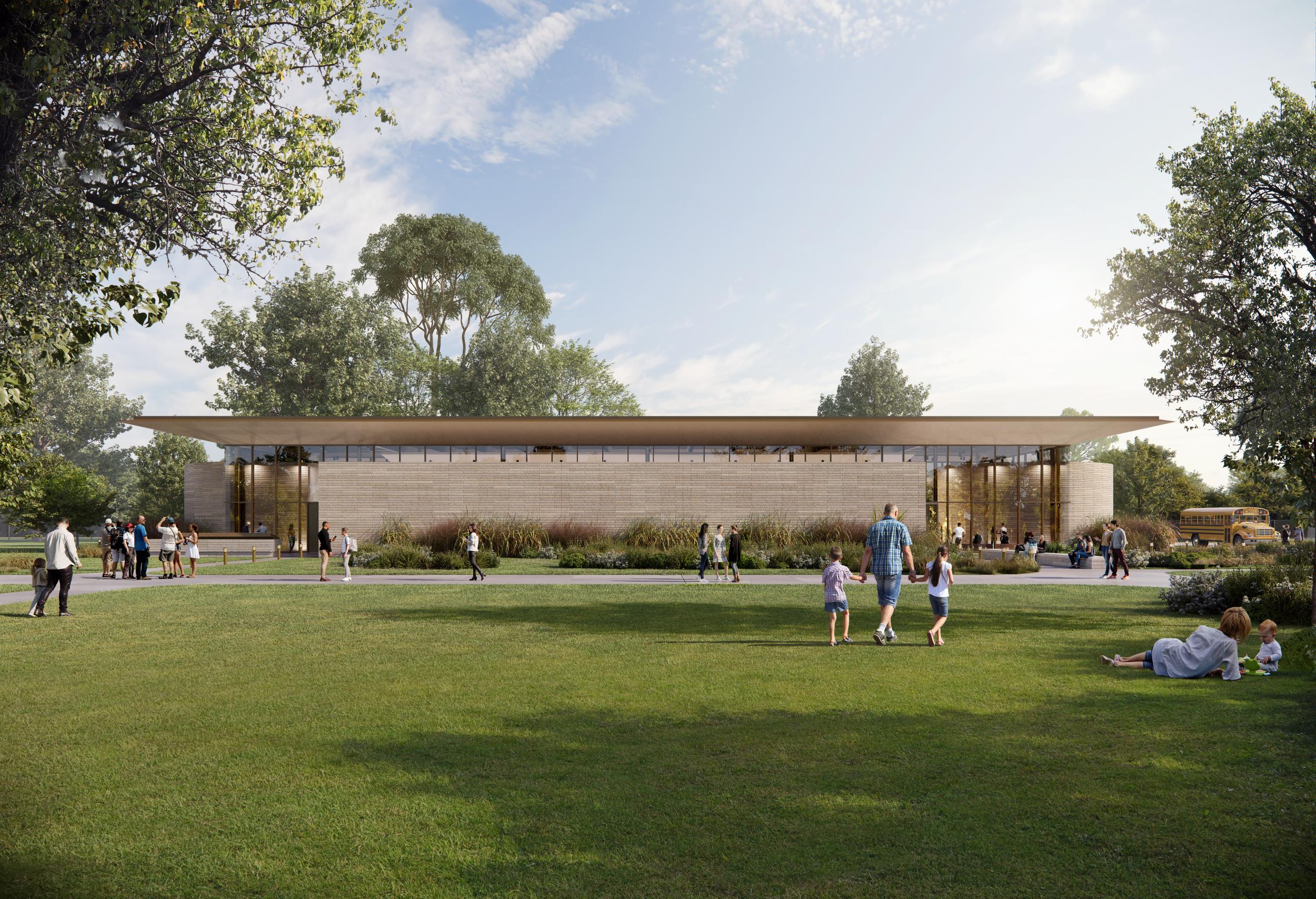 Visitors sit on the lawn outside the limestone and glass Eisenhower Education Center.