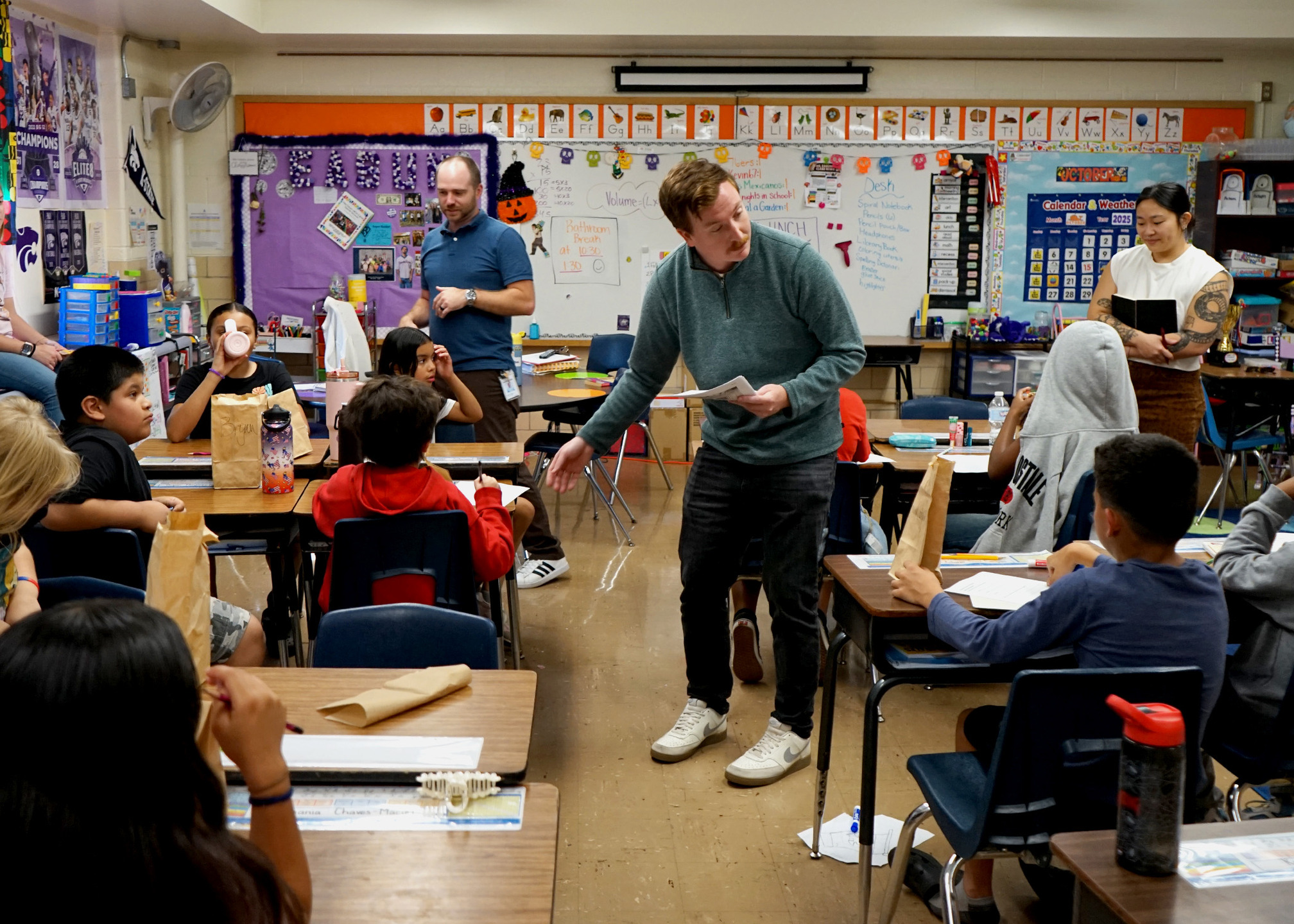 Multistudio designers and researchers handed out worksheets to gather student feedback at a classroom engagement session.