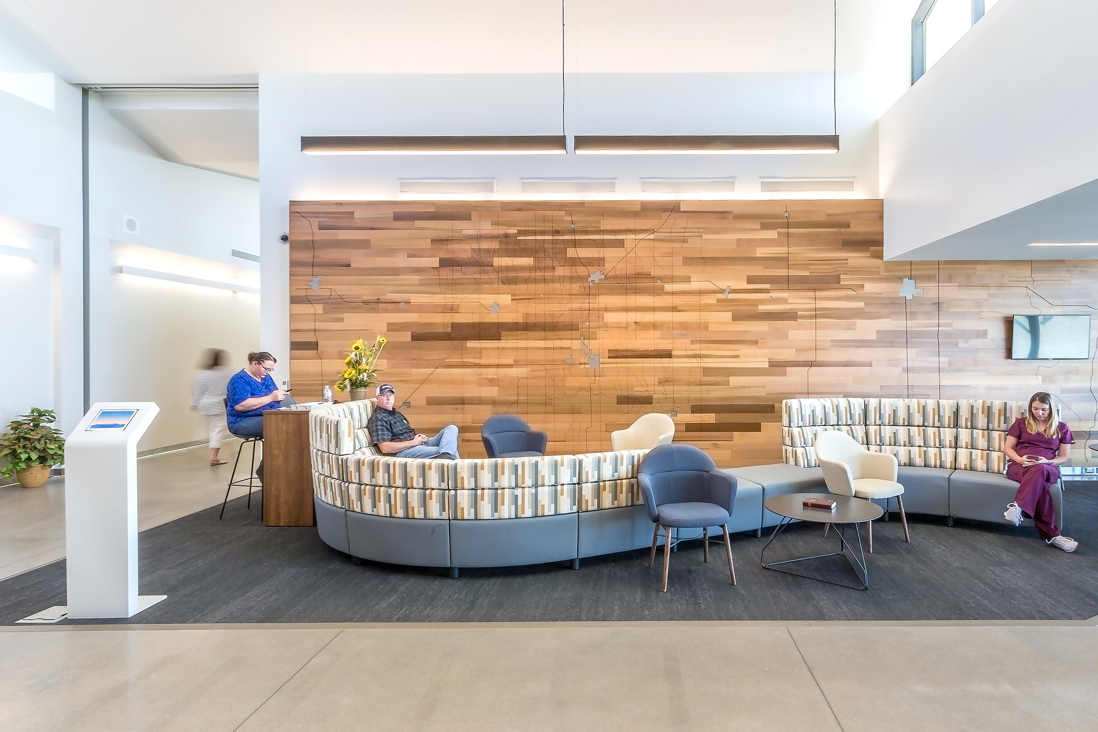 Visitors and staff rest in the lobby sitting area at Patterson Health Center