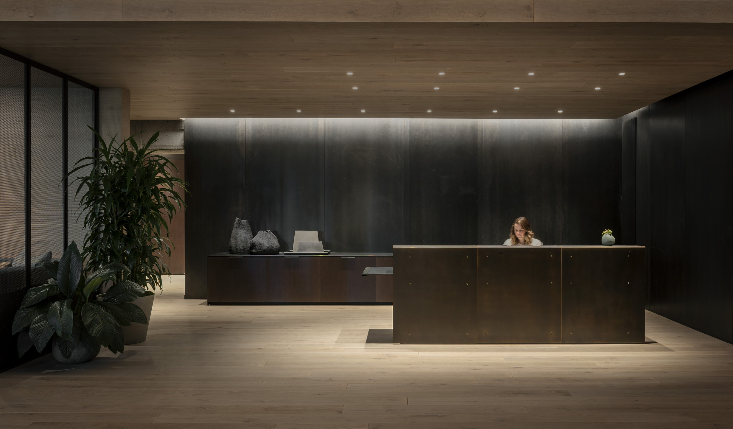 Tall windows and industrial finishes accent an open-air co-working space. 