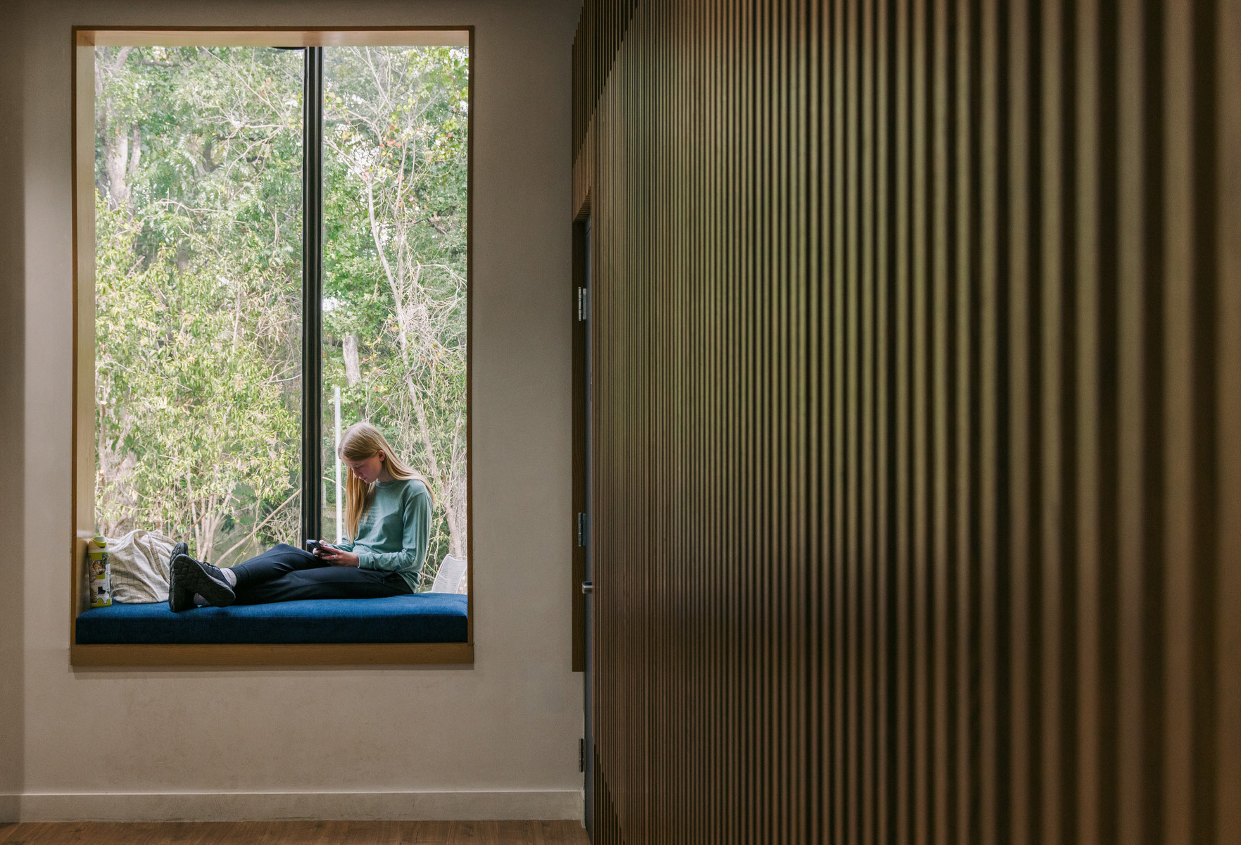 Students use window nooks in a multi-use dining area to study, chat, and text. 