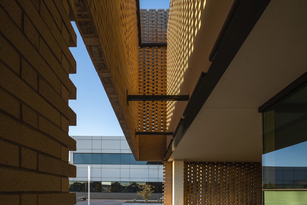 A detail shot of the Maricopa County Southeast Justice Center shows a brickwork facade near an entrance.