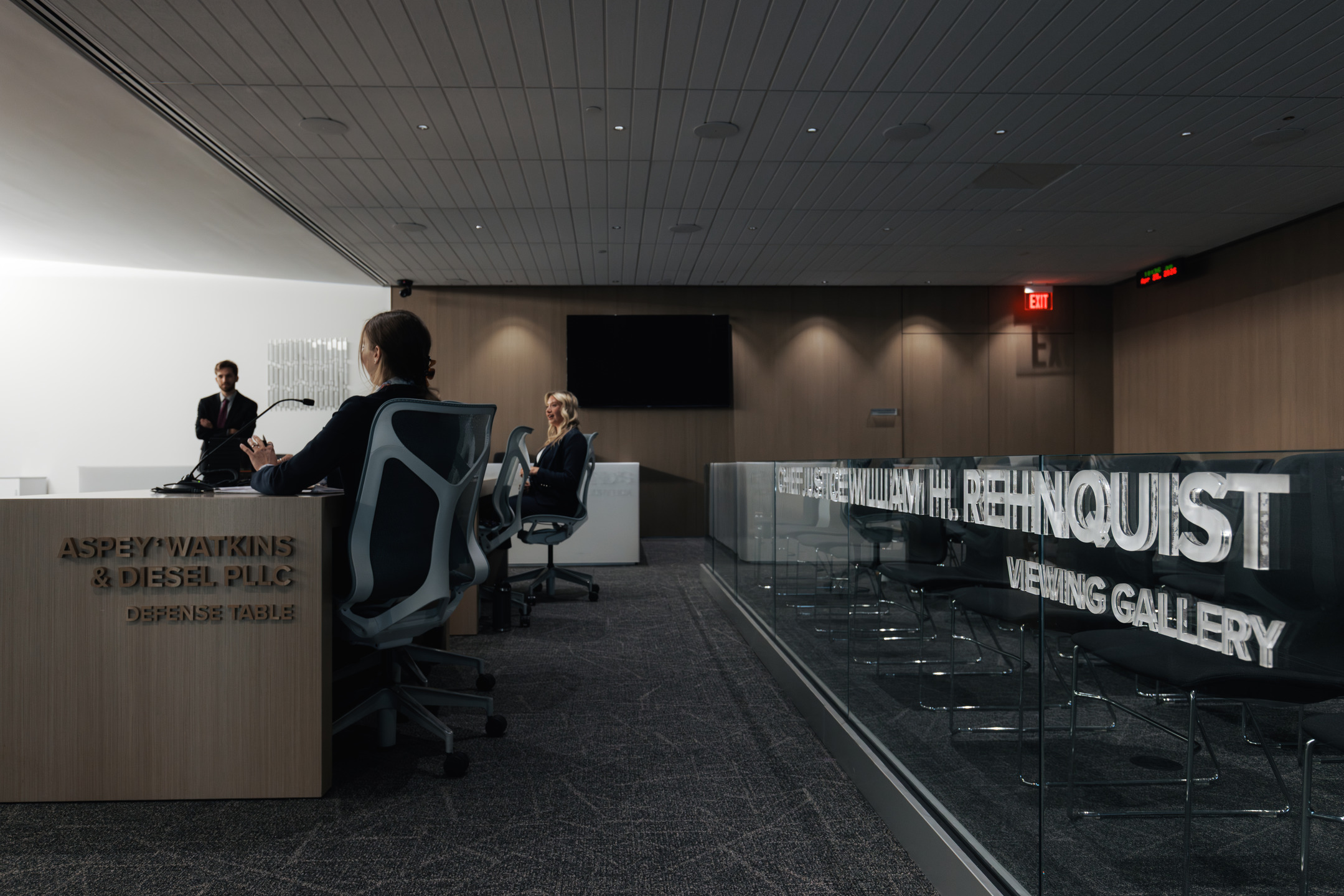 Students sit and stand in a mock courtroom, practicing litigation at the University of Arizona College of Law.