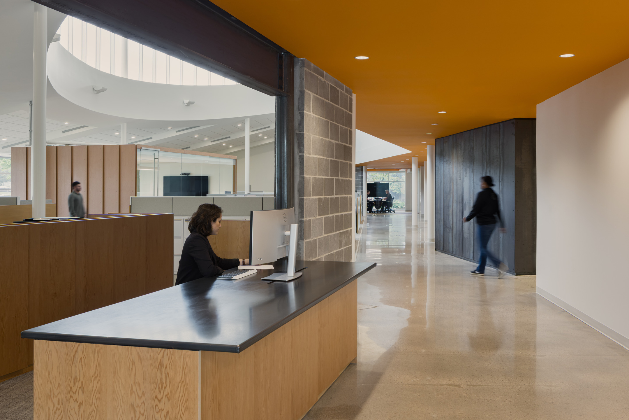 An office administrator sits behind the front desk at the renovated Newkirk Novak headquarters. 