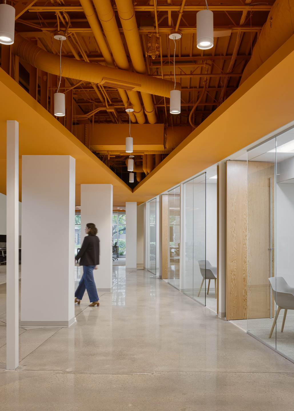 A dynamic orange ceiling plane reinforces the company’s branding.