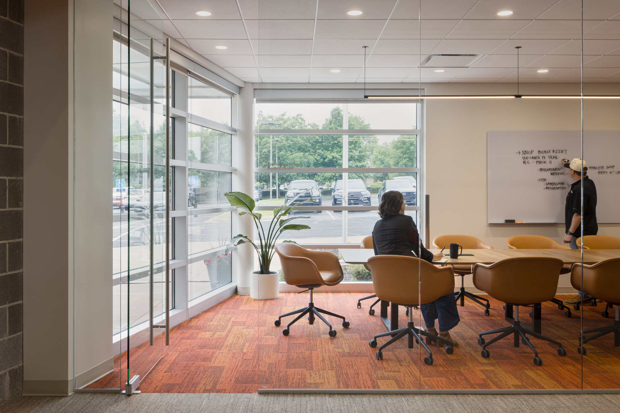 Floor-to-ceiling glass windows offers ample natural lighting in a meeting room at the renovated Newkirk Novak headquarters.