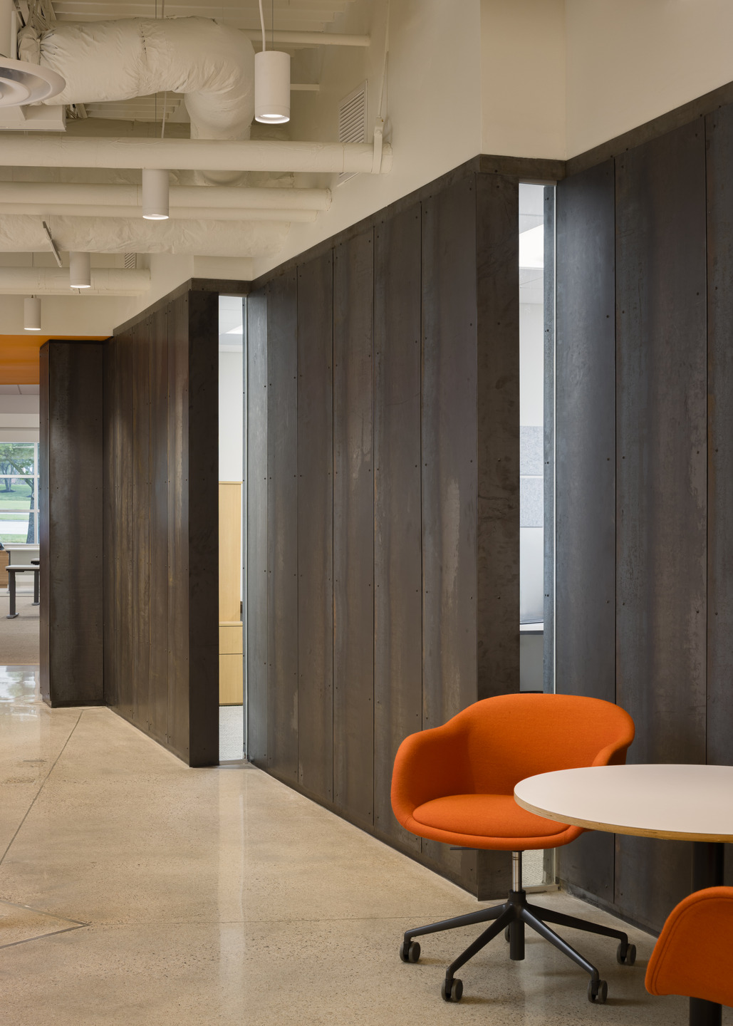 Hot rolled steel wall panels subtly reference the company’s own construction expertise.