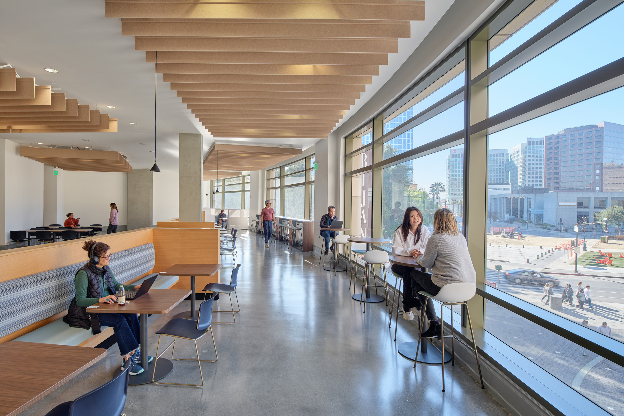 Students study and chat in communal work areas at the new SJSU student housing. 