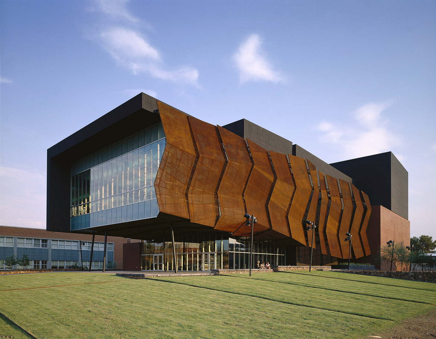 The Stevie Eller Dance Theatre features a rust-colored wire mesh facade.