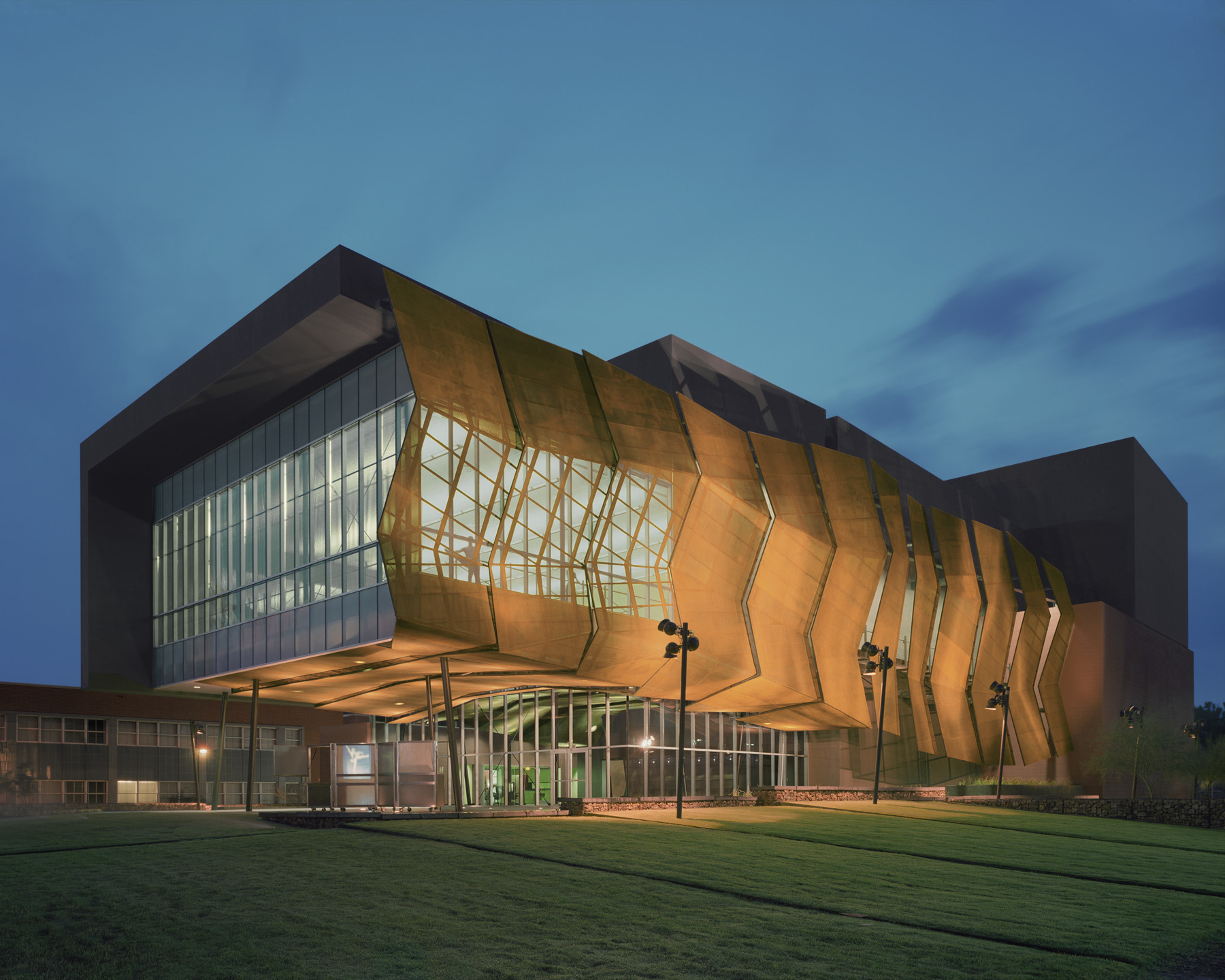 The Stevie Eller Dance Theatre features a rust-colored wire mesh facade.