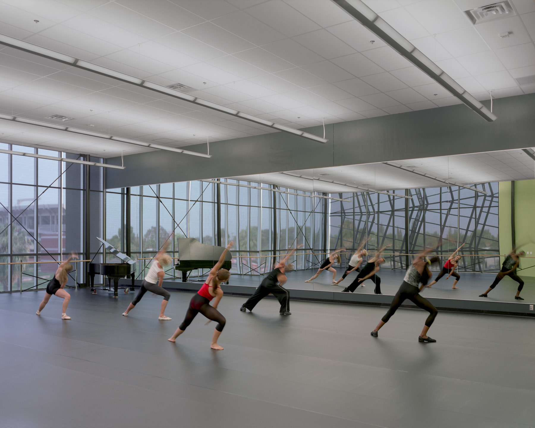 The dance studios feature floor-to-ceiling windows. 