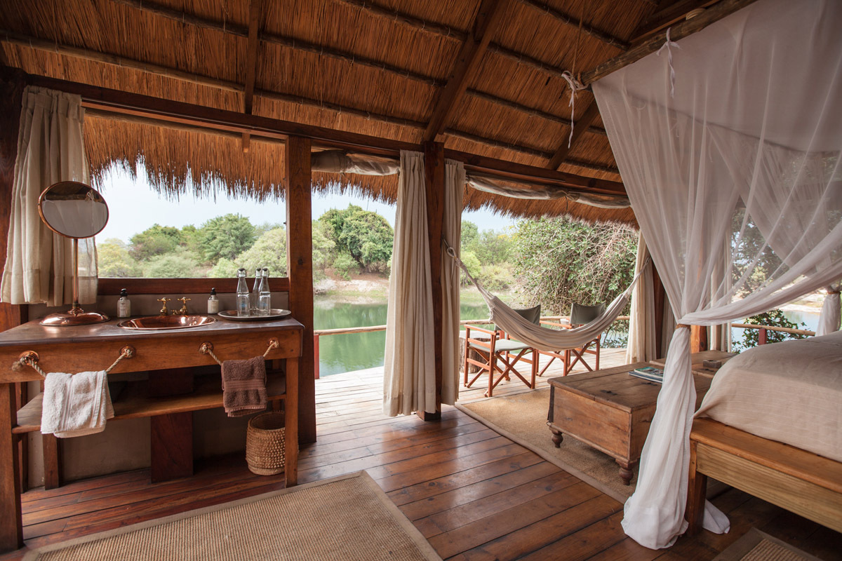 The views overlooking a river from a private island bedroom in Zambia