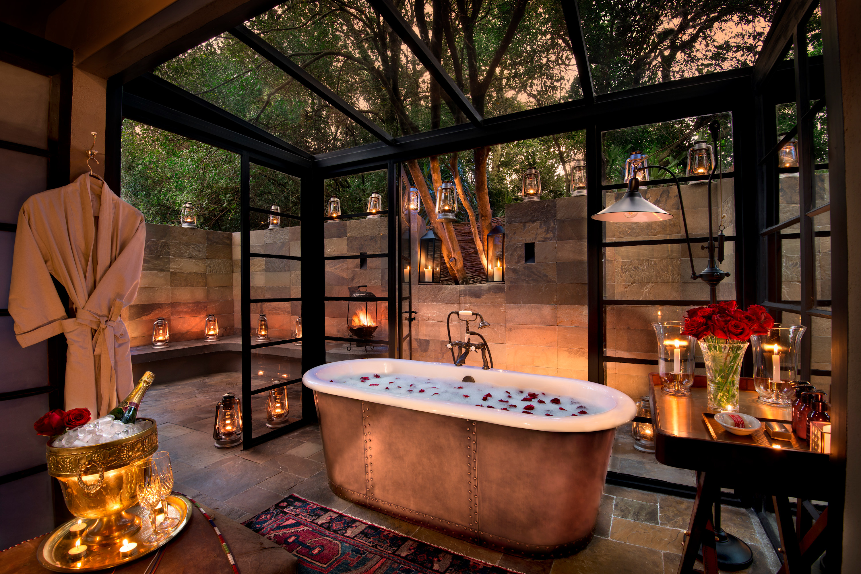 A copper bathtub with candelight atmostphere at a luxury safari lodge