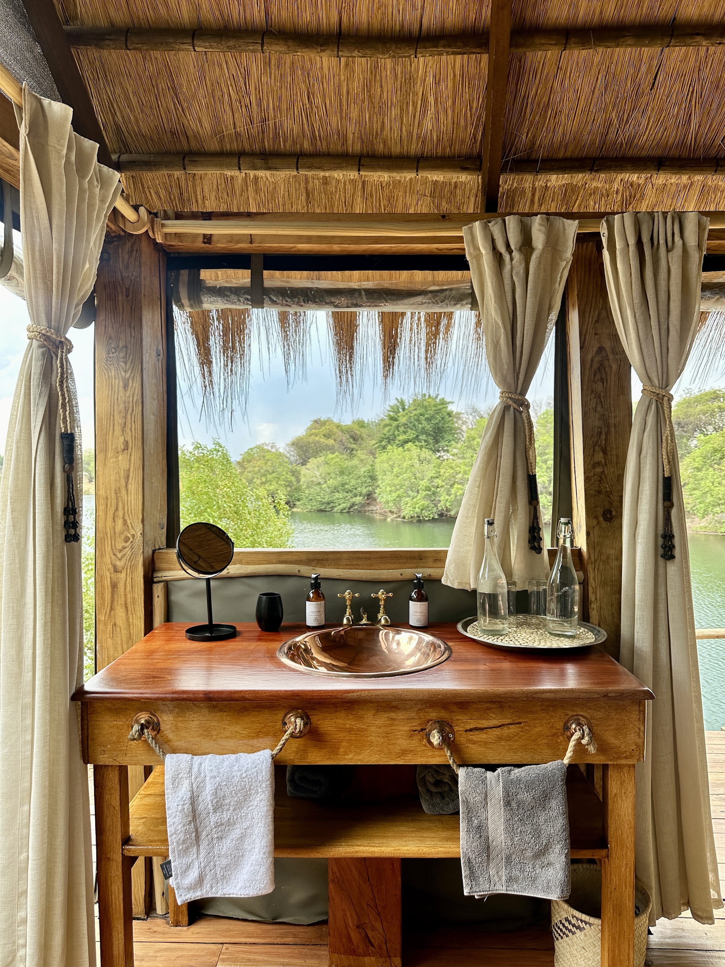 The view from the bathroom overlooking the river at Sindabest Private Island Lodge