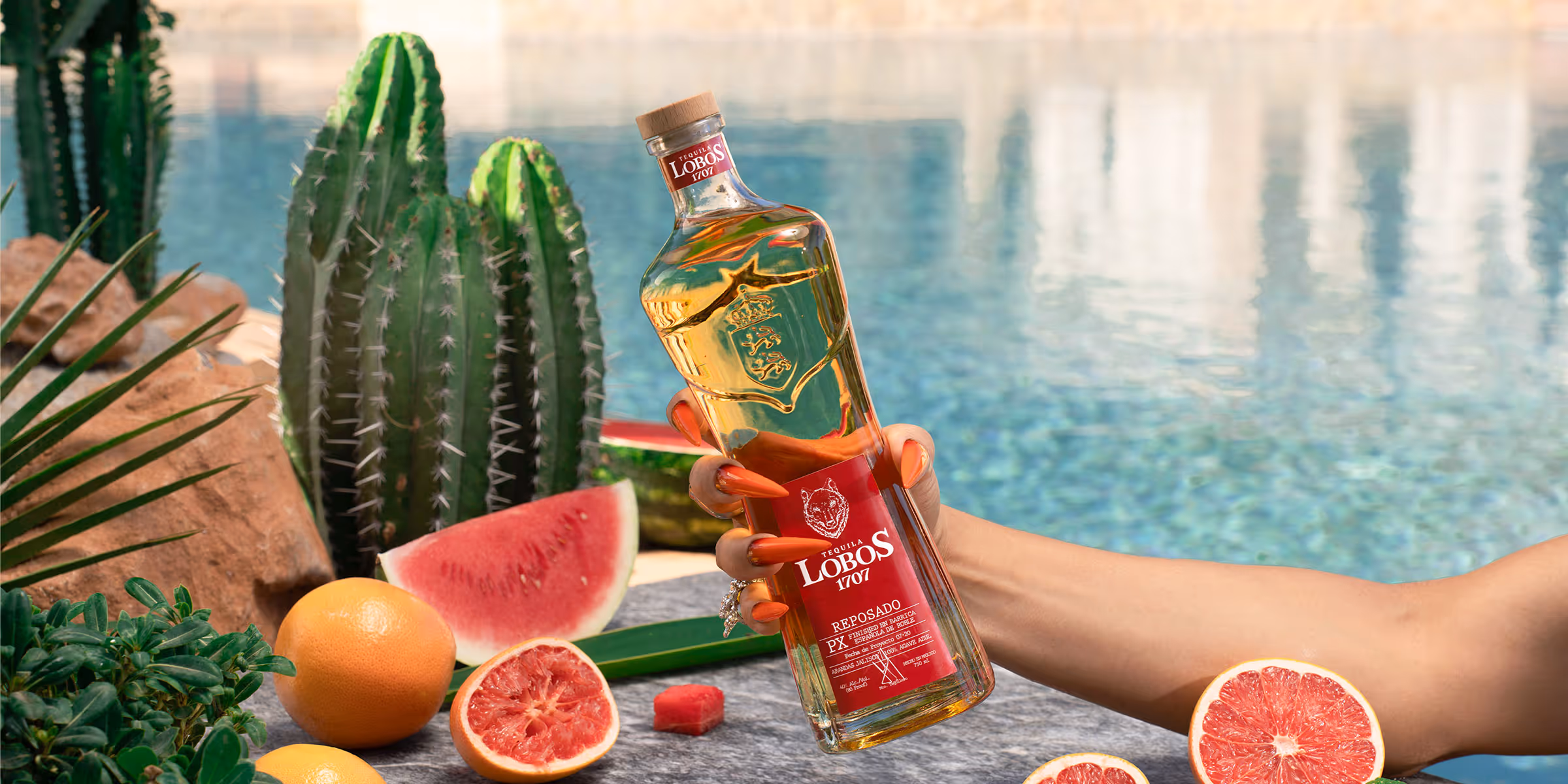 A Lobos 1707 Reposado bottle with a water background.
