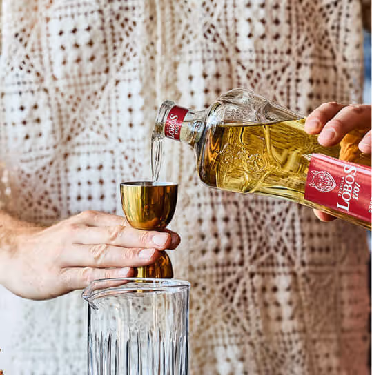 Lobos 1707 reposado Tequila being poured into a glass