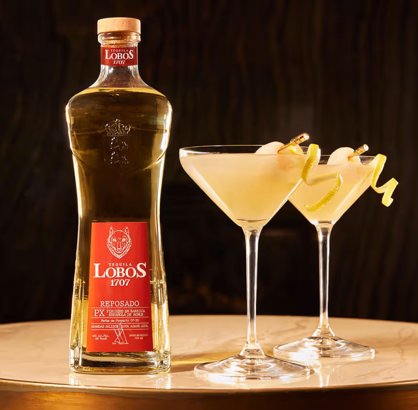 Lobos 1707 reposado Tequila sitting next to two cocktails