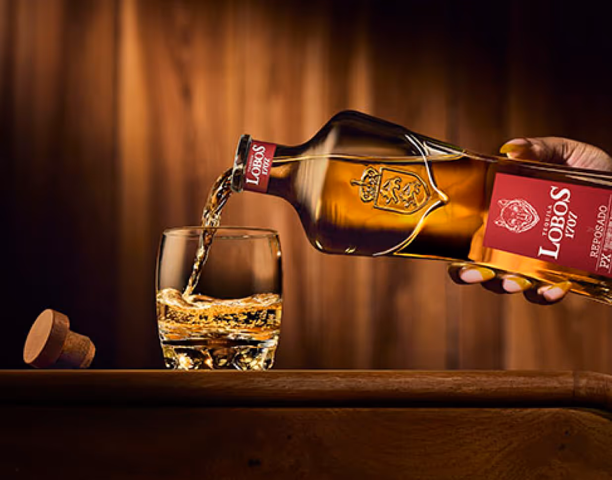 Lobos 1707 reposado Tequila being poured into a glass