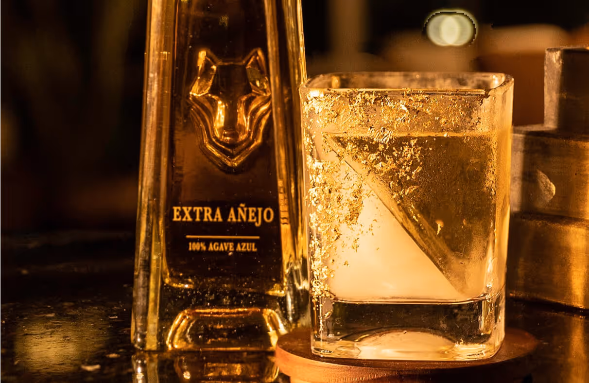 Extra Anejo Lobos 1707 Tequila bottle with drink next to it. 