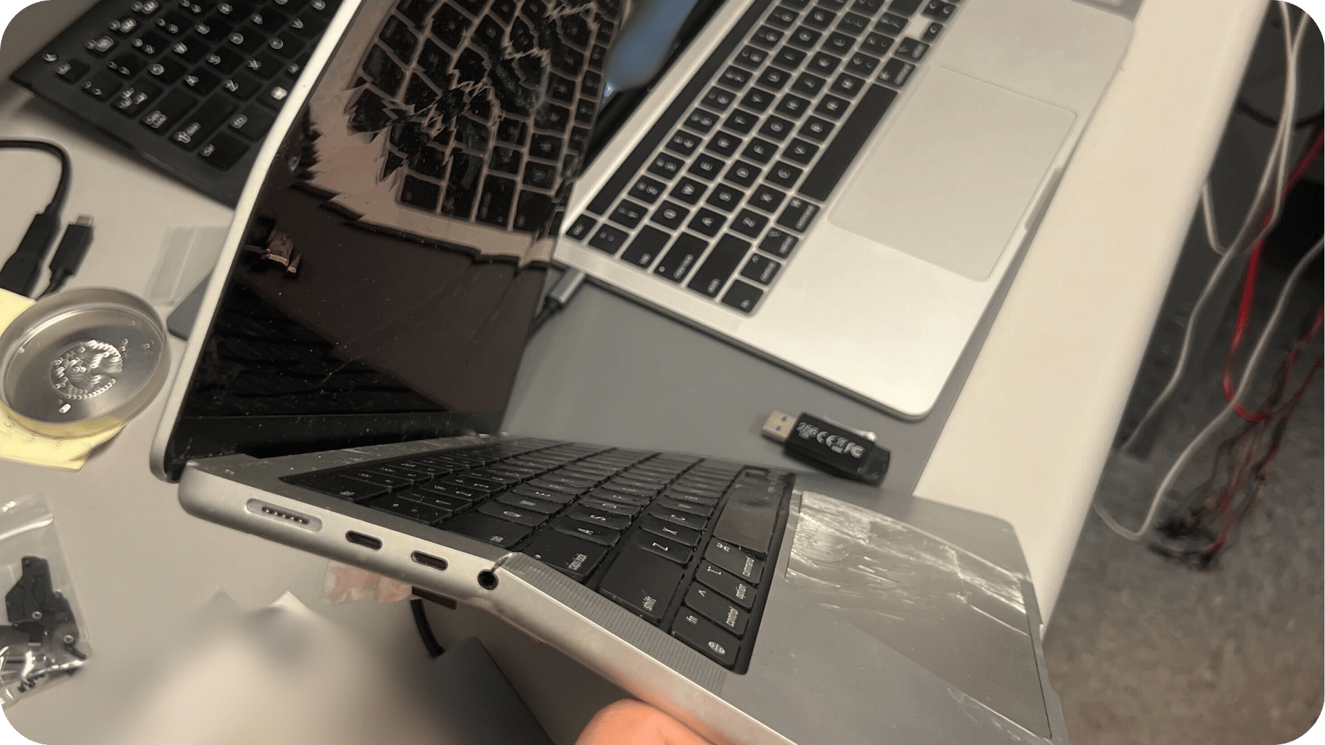 a photo of the severely damaged MacBook on the side