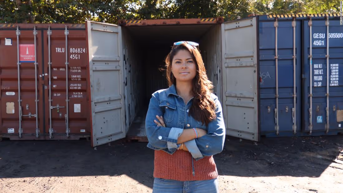Carla Gautier posing in front of a shipping container.