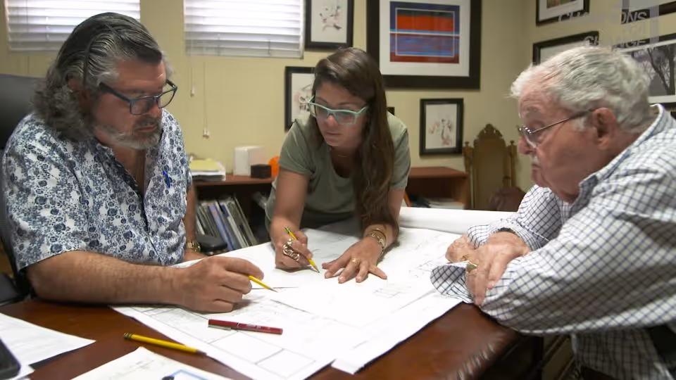 Puerto Rican architect Carla Gautier Castro sharing plans with a team.