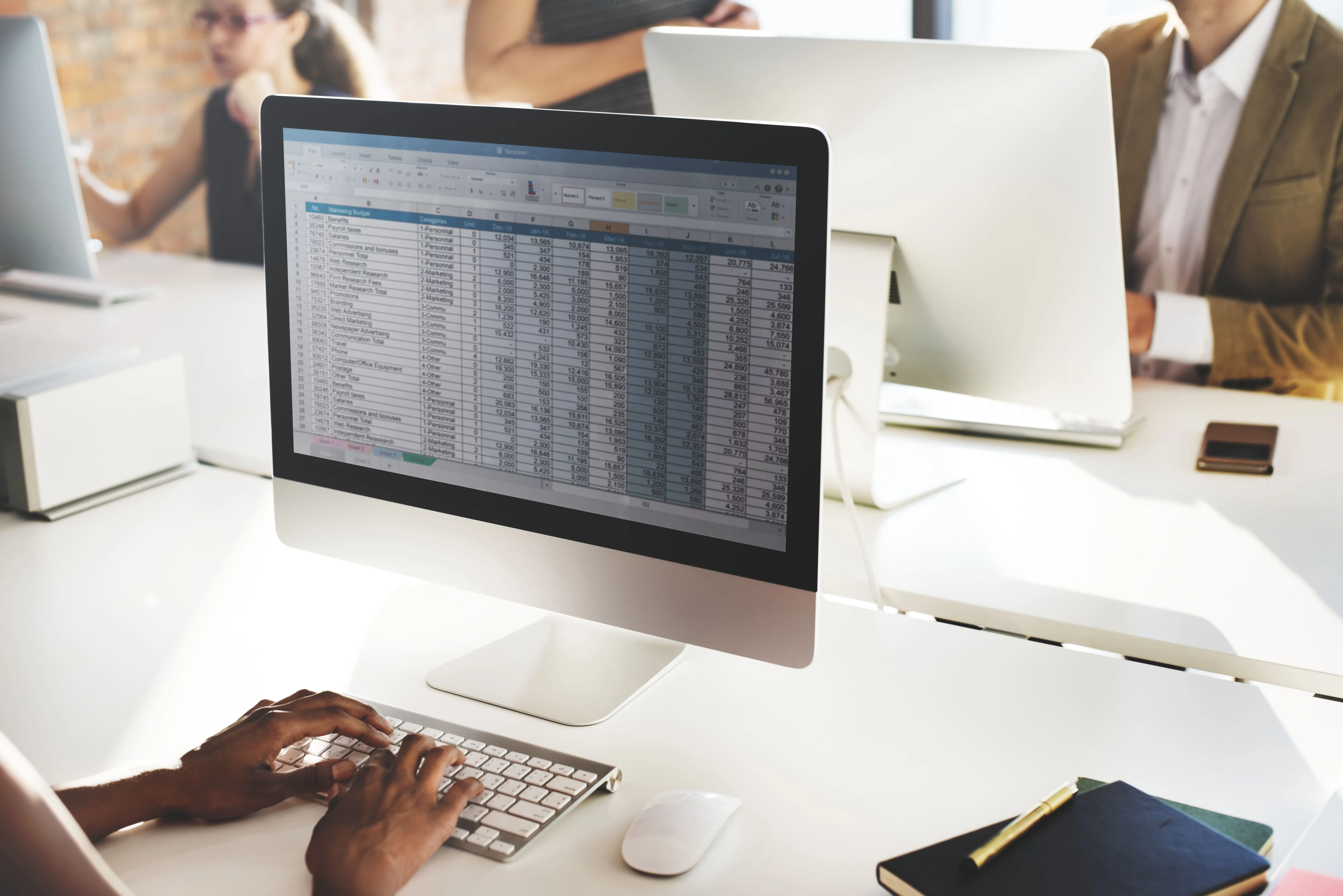 A man using a spreadsheet instead of online e-commerce sales tax software to prepare his taxes