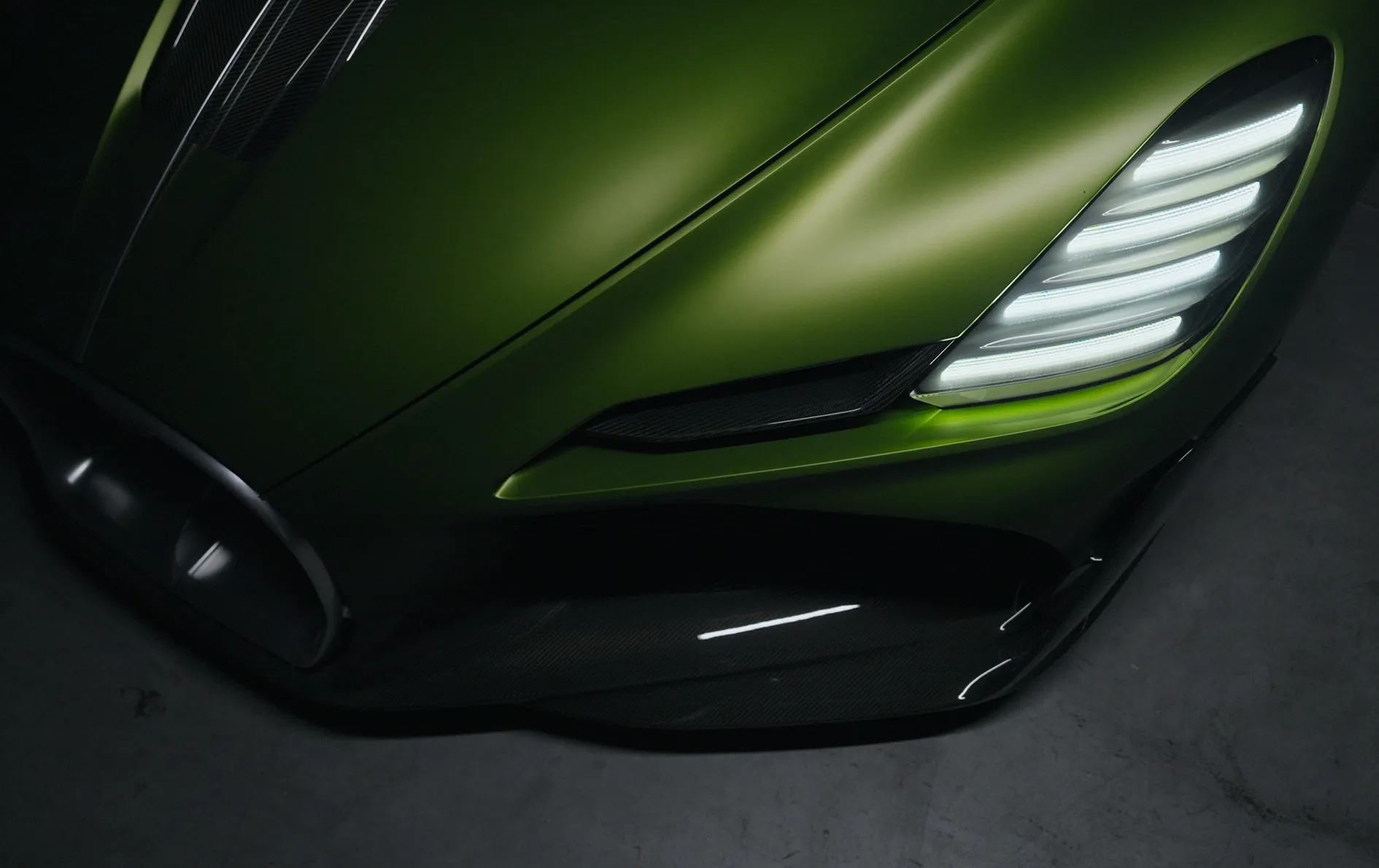 Sportwagen in metallic groene kleur met moderne LED-koplampen.