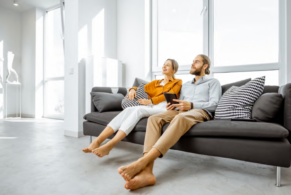 couple sitting on the couch in their clean home