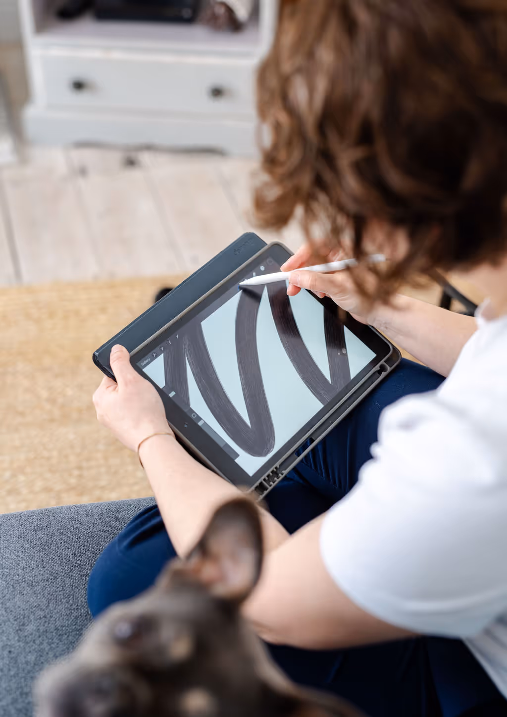 Melissa and her dog truffle using an ipad