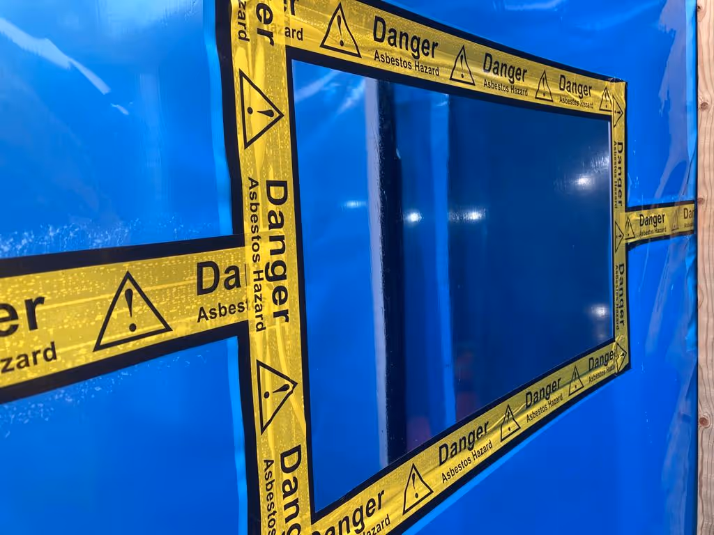 A blue door with yellow caution signs on it.