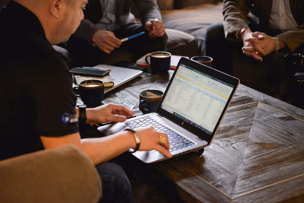Man working on a laptop at a coffee table