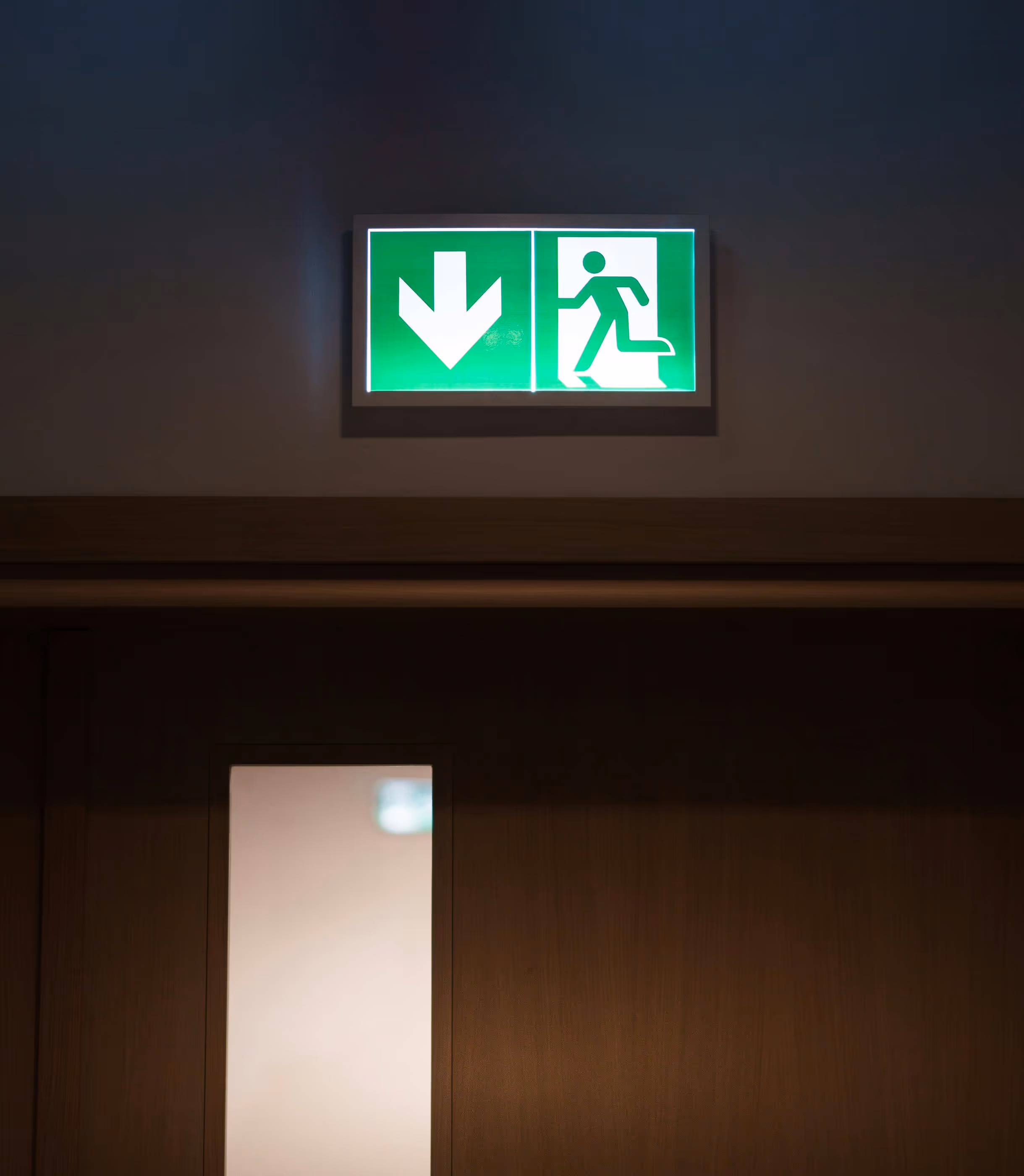 Illuminated green fire exit sign