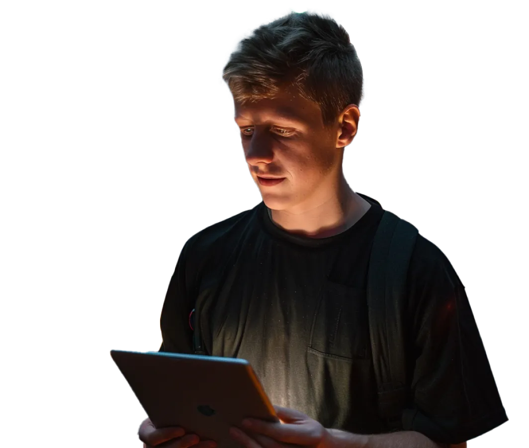 A man holding a tablet in his hands.